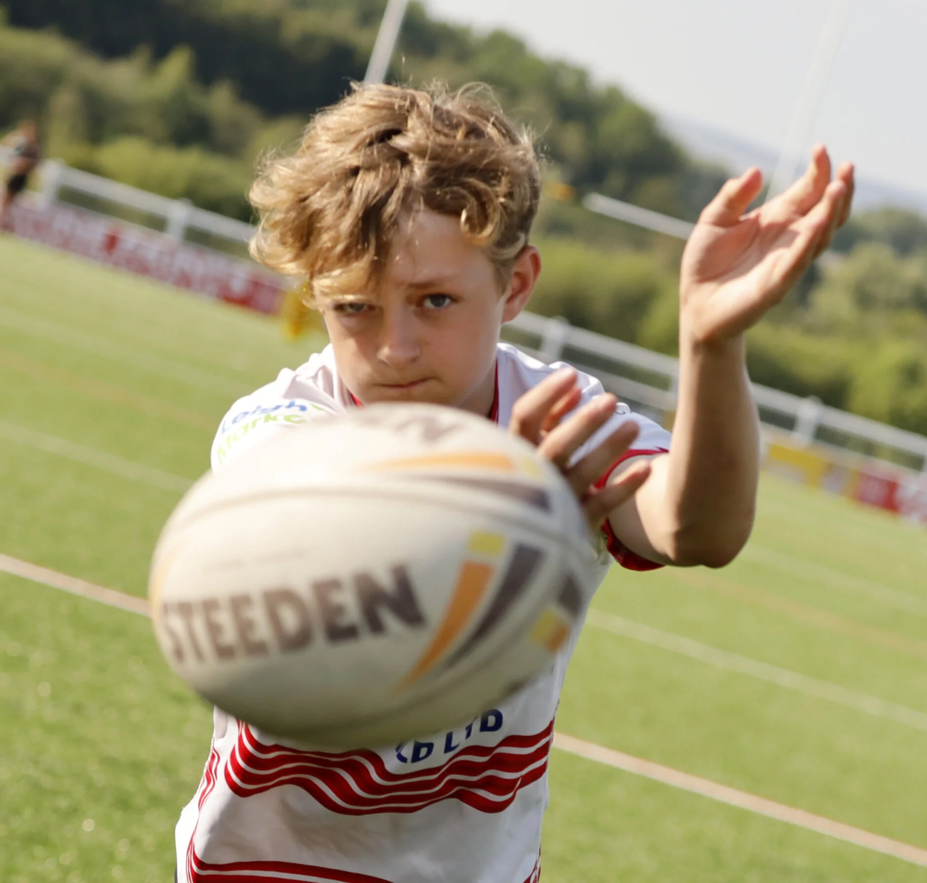 Boy passing rugby ball at Leigh Miners Rangers Rugby League Academy