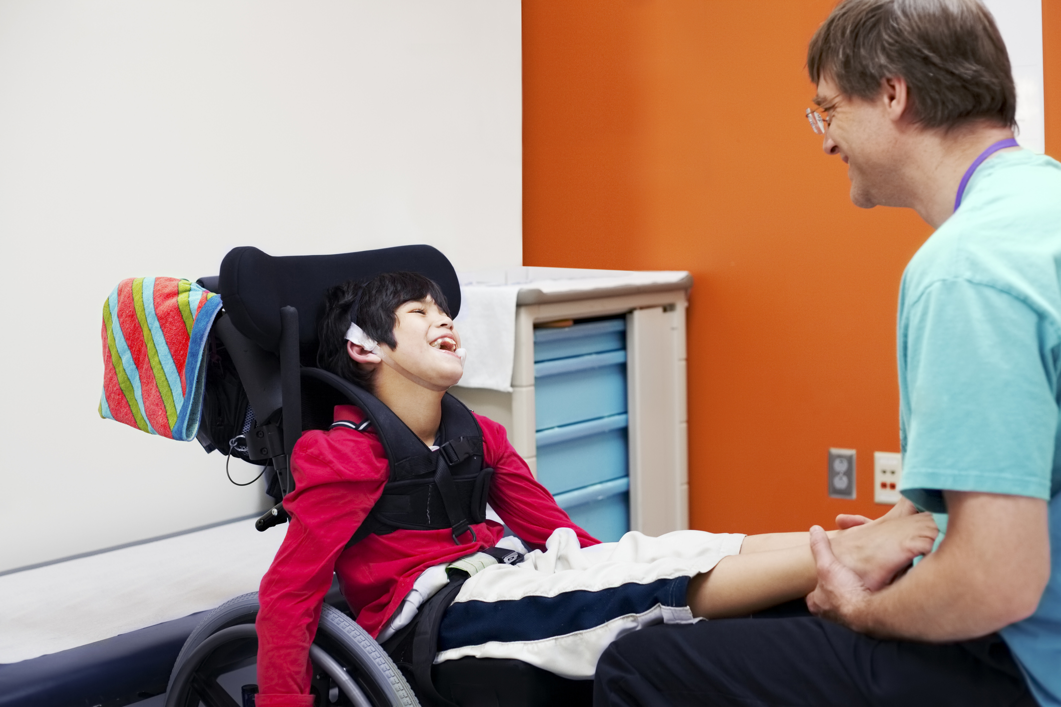 Disabled boy in wheelchair with his doctor